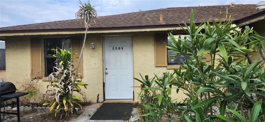 5509 Riddle Road Holiday, FL 34690 - Photo 2 of 13 a front view of a house with a plant