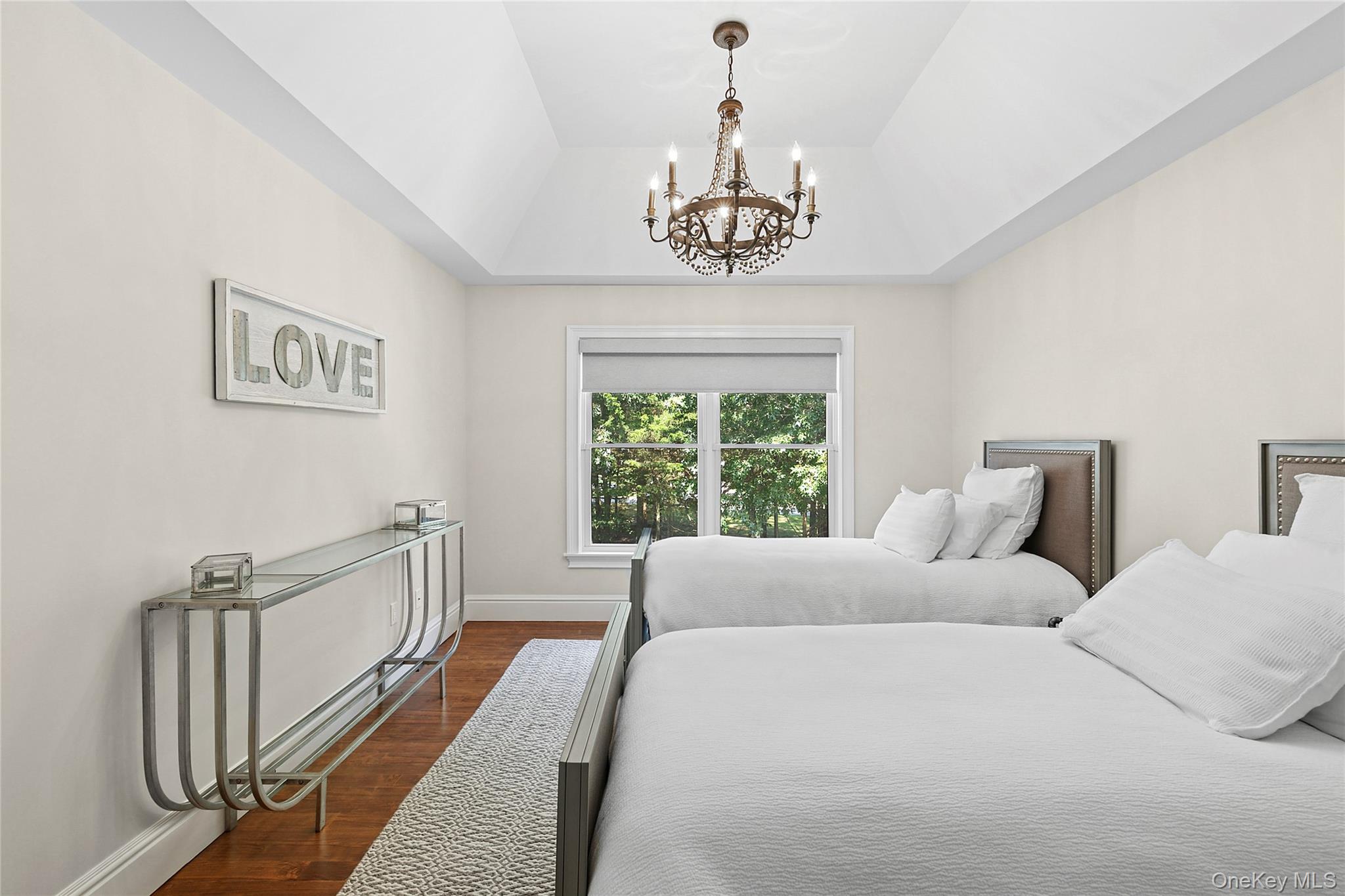 3470 North Bayview Road Southold, NY 11971 - Photo 13 of 25 Bedroom featuring wood finished floors and a chandelier