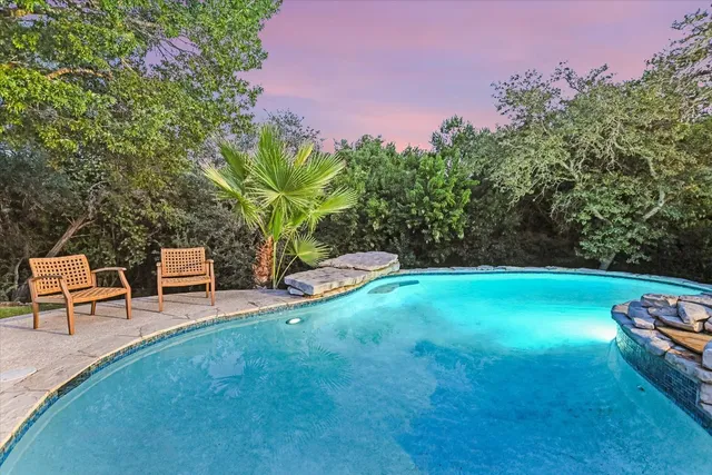 a backyard of a house with table and chairs