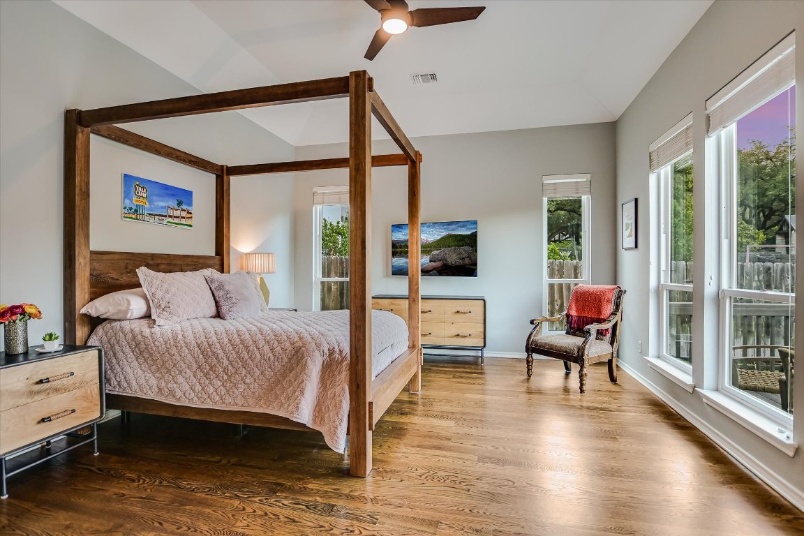 5507 Mt Bonnell Road Austin, TX 78731 - Photo 22 of 35 a bedroom with a bed and large windows