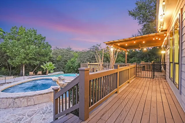 a view of a balcony with wooden floor and fence