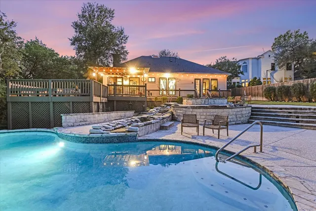 a view of a swimming pool with outdoor seating