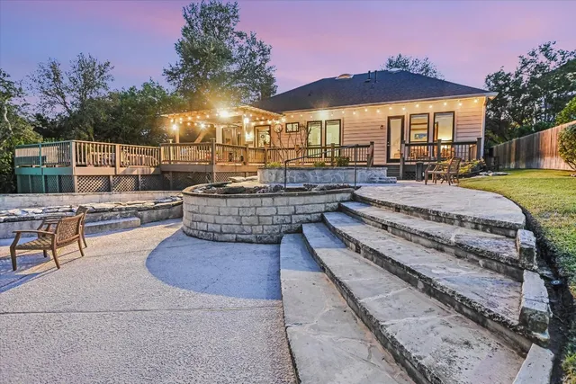 a view of a house with swimming pool and sitting area