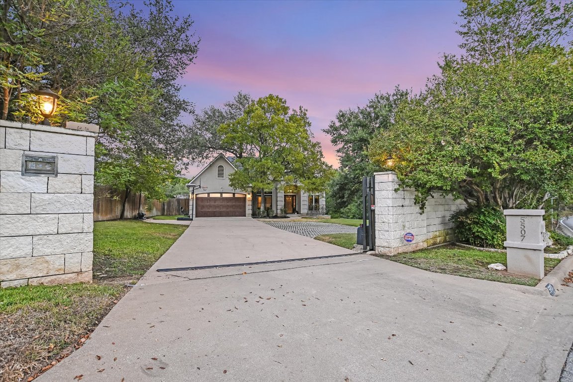 5507 Mt Bonnell Road Austin, TX 78731 - Photo 6 of 35 a front view of a house with a yard and a tree