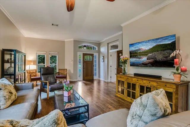 a living room with furniture and a flat screen tv