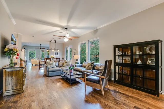 a living room with furniture and a book shelf