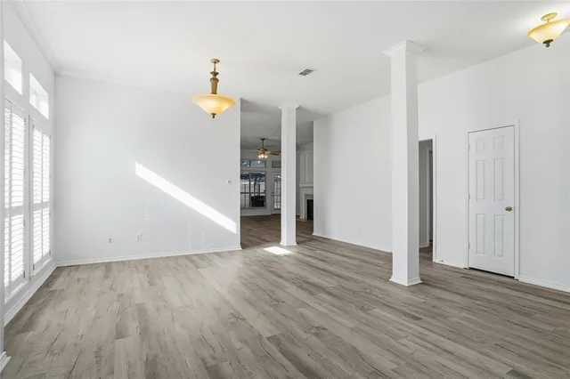 an empty room with wooden floor and a window