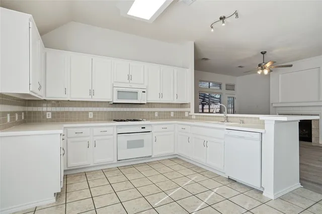 a view of an empty room with window and cabinet