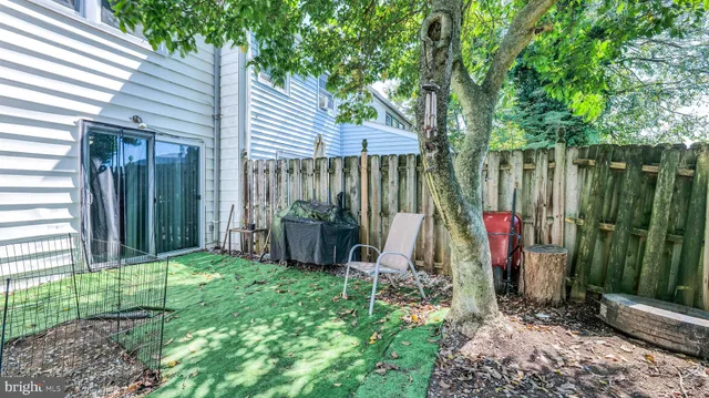 a view of a backyard with a small cabin and chair