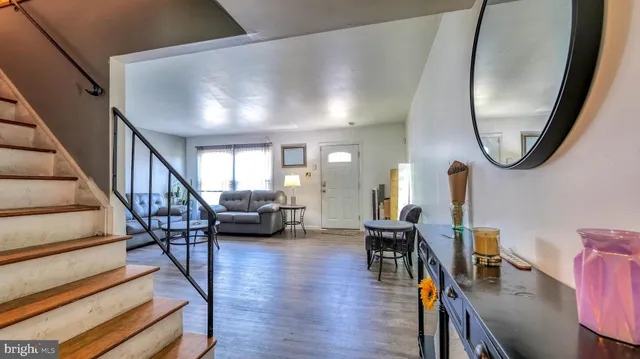 a view of a livingroom with furniture and a mirror