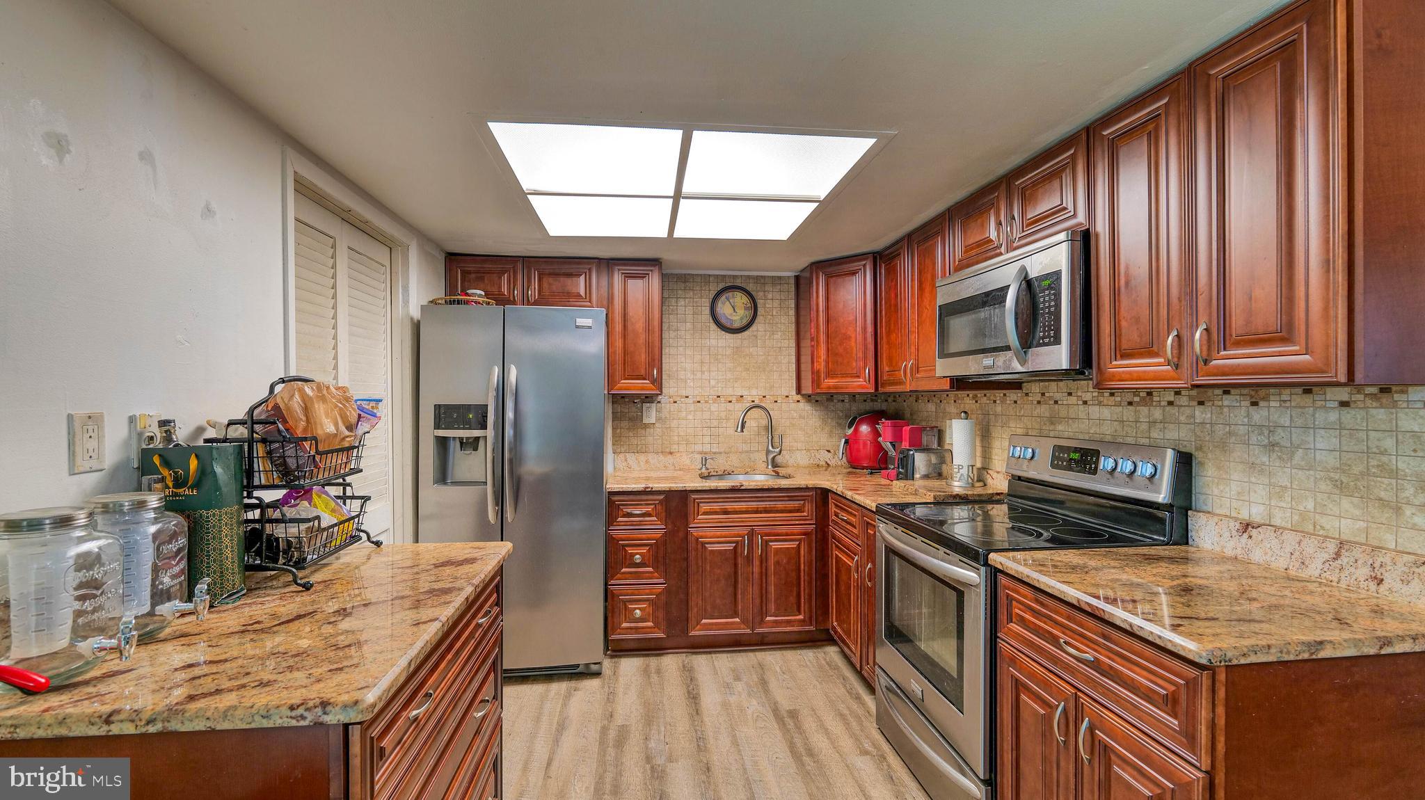 9 Ridgewood Place Willingboro, NJ 08046 - Photo 9 of 19 a kitchen that has a lot of cabinets stainless steel appliances and wooden floor