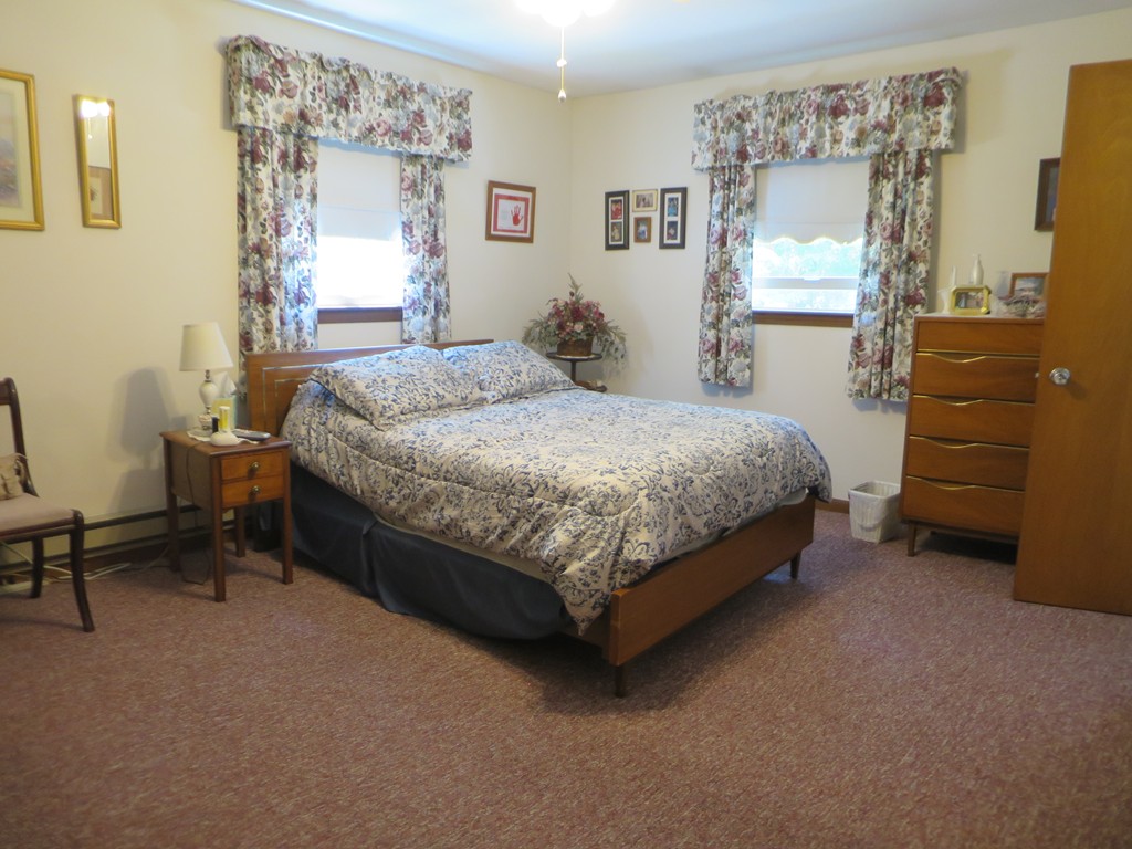 130 Town Farm Road Monson, MA 01057 - Photo 8 of 15 a bed sitting in a bedroom next to a window