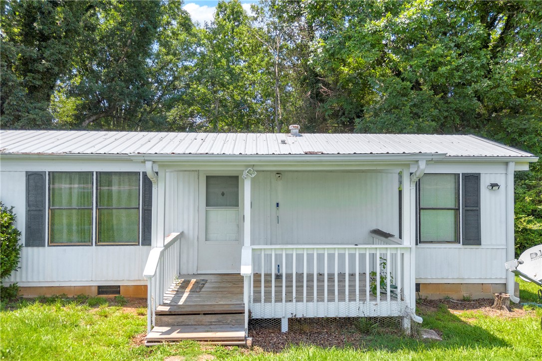 150 Newberry Road Walhalla, SC 29691 - Photo 3 of 47 A quaint residence features a covered front porch and mature trees for natural shade.