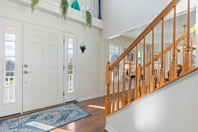 a view of an entryway with wooden floor