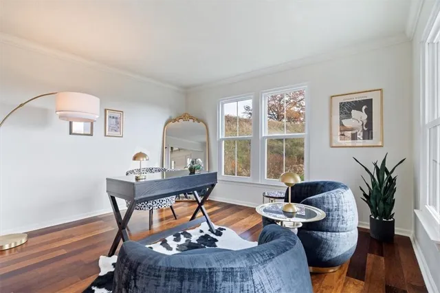 a dining room with furniture a chandelier and wooden floor