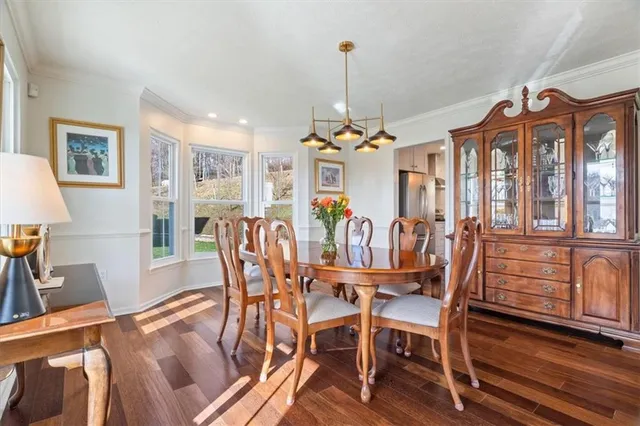 a view of a dining room with furniture wooden floor and chandelier