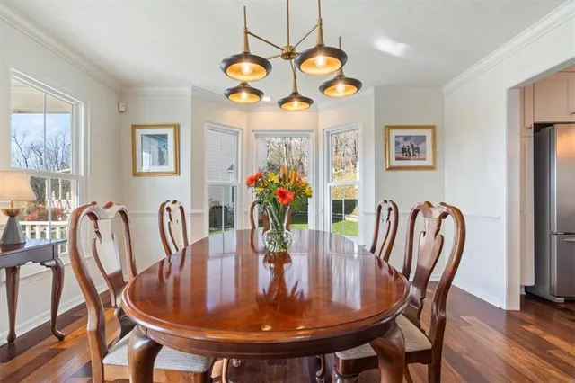 a view of a dining room with furniture and chandelier