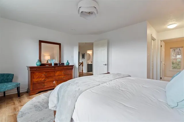 a view of bedroom with wooden floor
