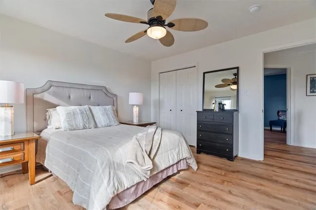 a bedroom with a bed and a lamp on the dresser