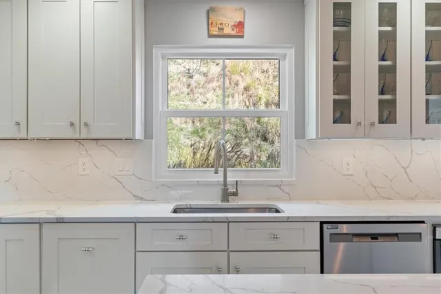 a kitchen with granite countertop a sink and a window
