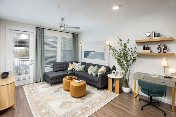 a living room with furniture and a potted plant