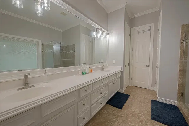 a spacious bathroom with double sink and a large mirror