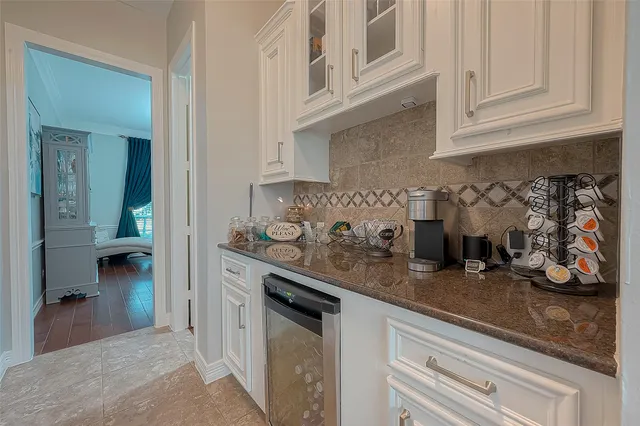 a kitchen with white cabinets and a sink