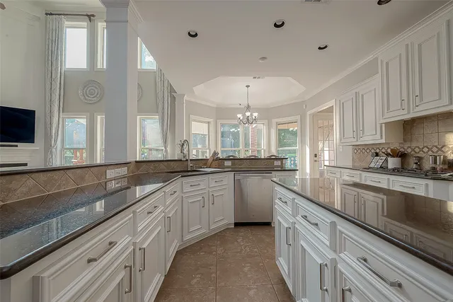 a kitchen with granite countertop a sink and a stove