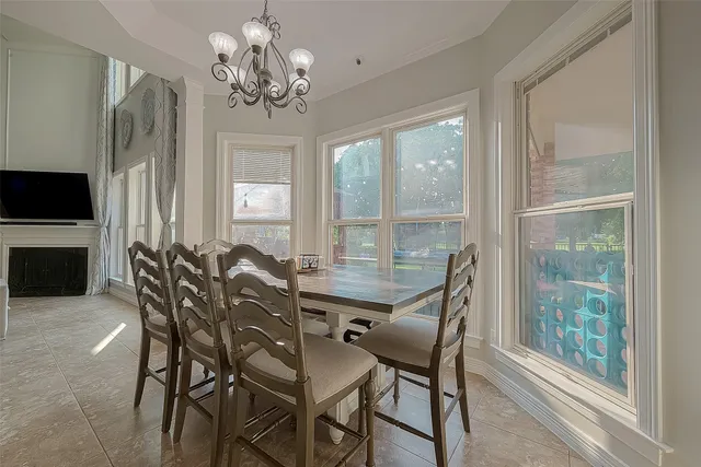 a view of a dining room with furniture and chandelier