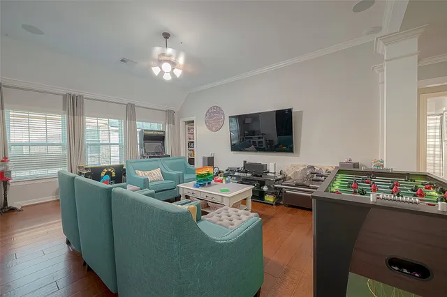 a living room with furniture and a flat screen tv