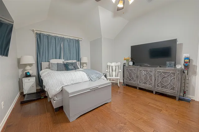 a bedroom with a bed window and a flat screen tv