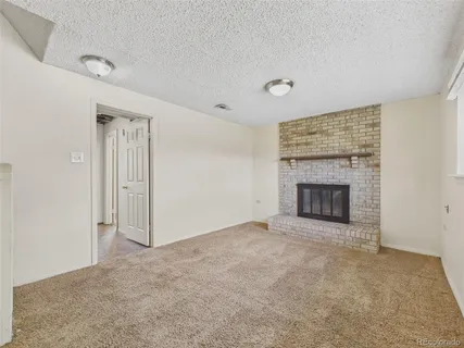 a view of empty room with a fireplace