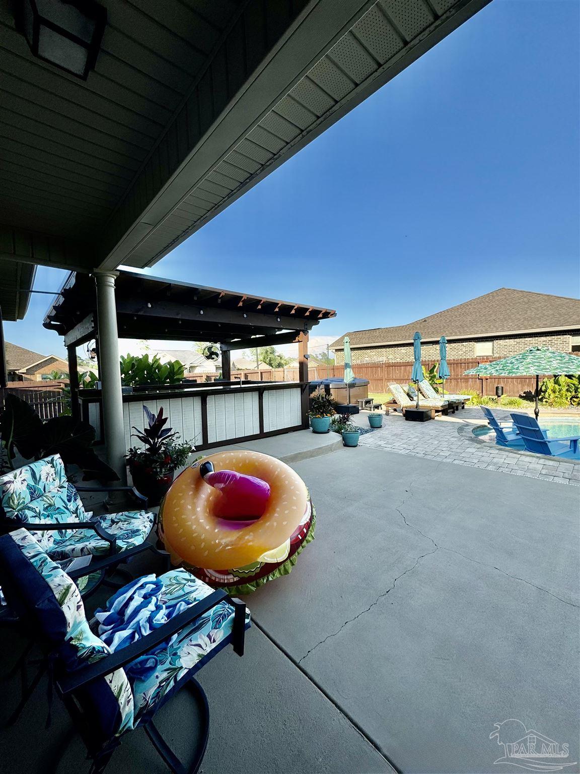 1700 Kahuna Way Cantonment, FL 32533 - Photo 12 of 34 a room with lots of table and chairs