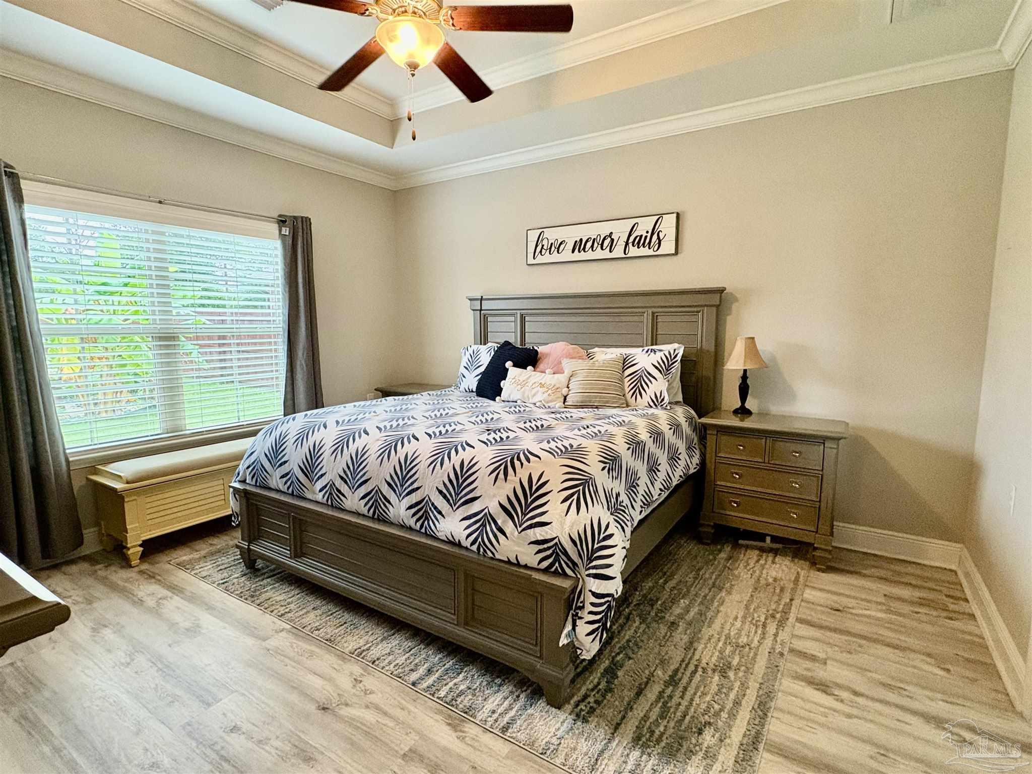 1700 Kahuna Way Cantonment, FL 32533 - Photo 18 of 34 a bedroom with a bed and wooden floor