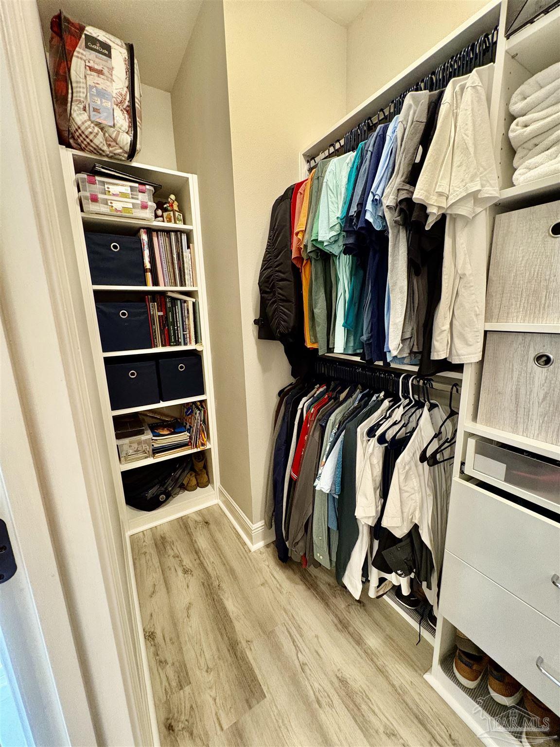 1700 Kahuna Way Cantonment, FL 32533 - Photo 19 of 34 a view of walk in closet with clothes and shoes