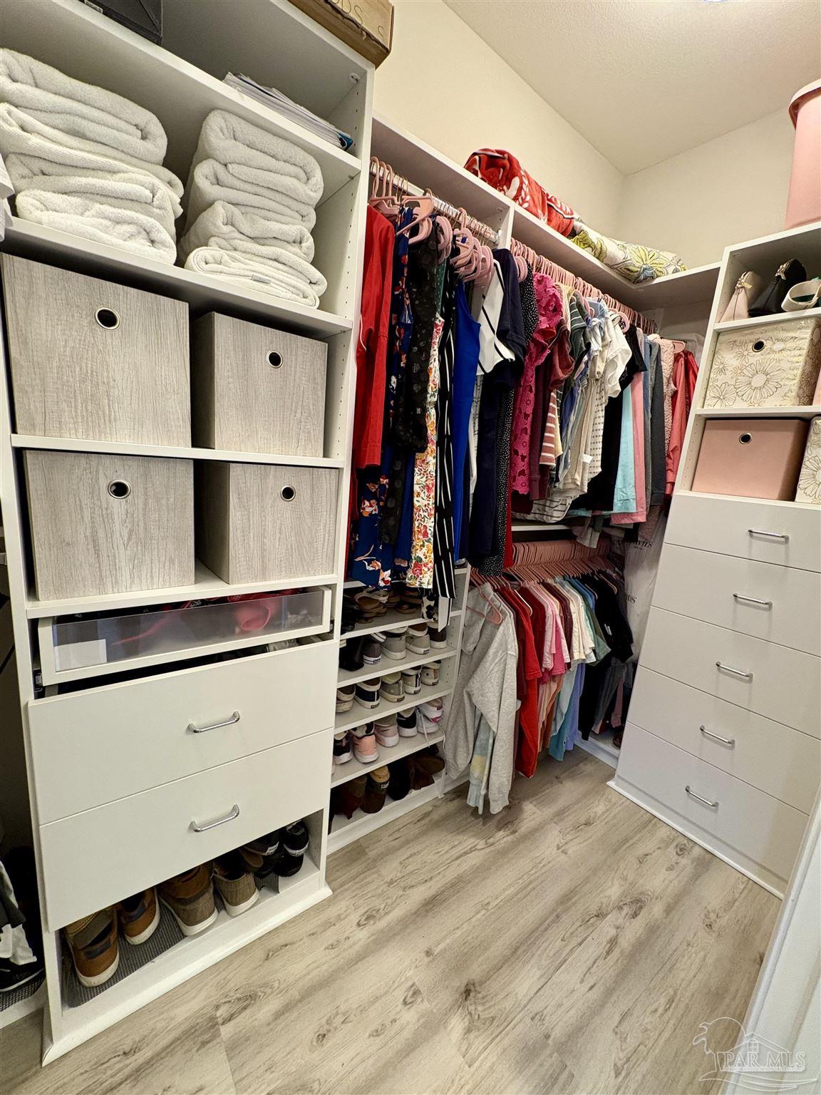 1700 Kahuna Way Cantonment, FL 32533 - Photo 20 of 34 a view of walk in closet with clothes and shoes