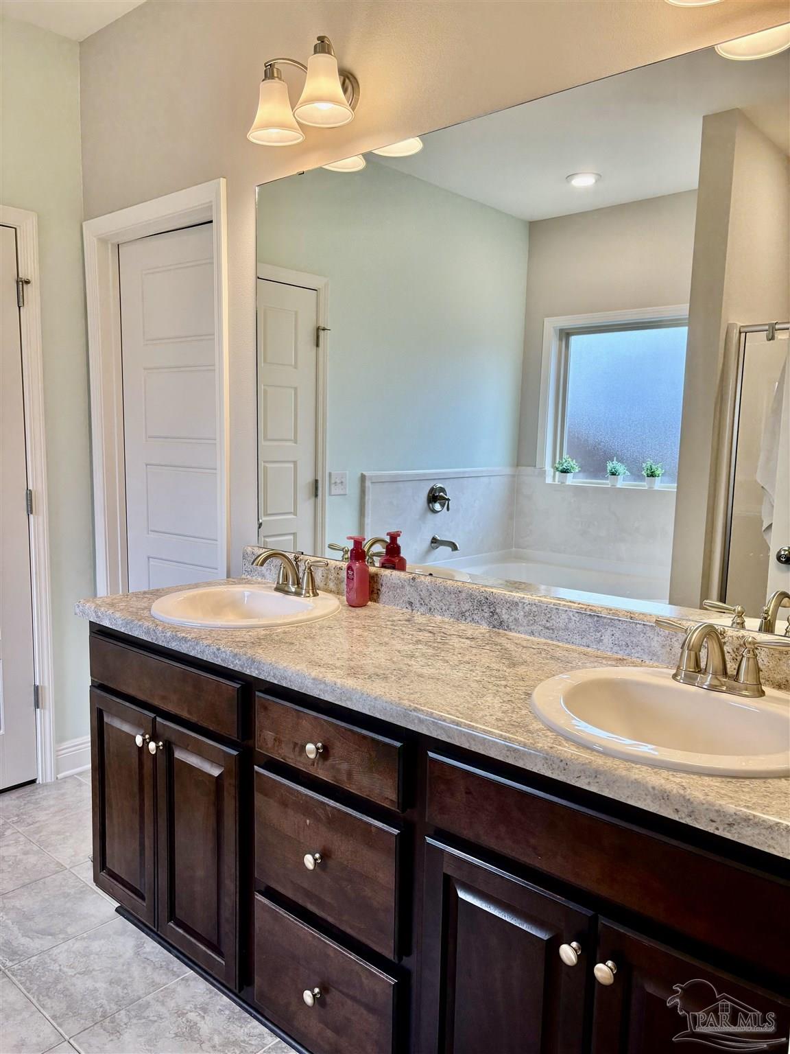 1700 Kahuna Way Cantonment, FL 32533 - Photo 21 of 34 a bathroom with a granite countertop sink and a mirror