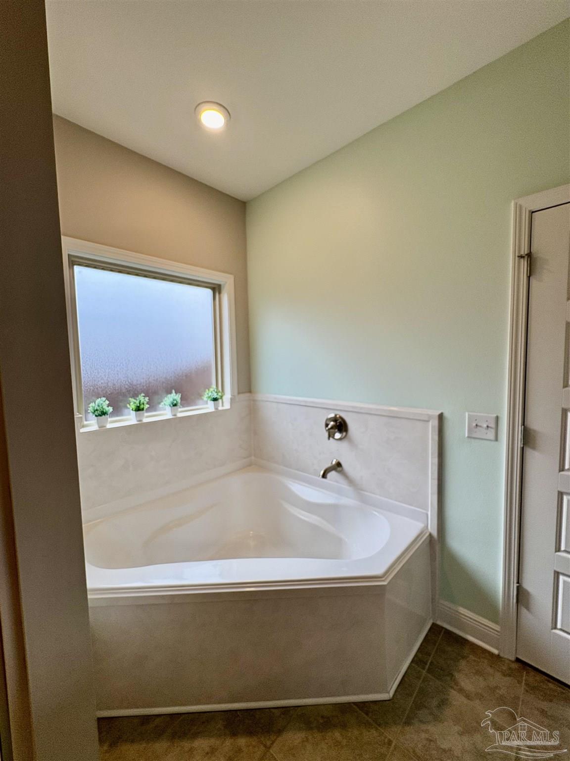 1700 Kahuna Way Cantonment, FL 32533 - Photo 22 of 34 a bathroom with a tub and a mirror