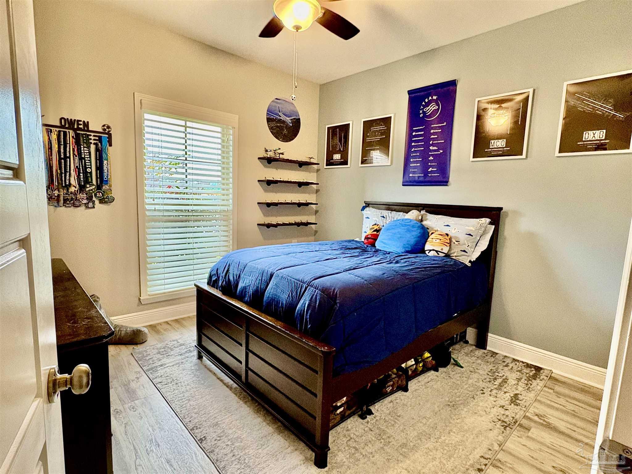 1700 Kahuna Way Cantonment, FL 32533 - Photo 24 of 34 a bedroom with a bed and cabinets