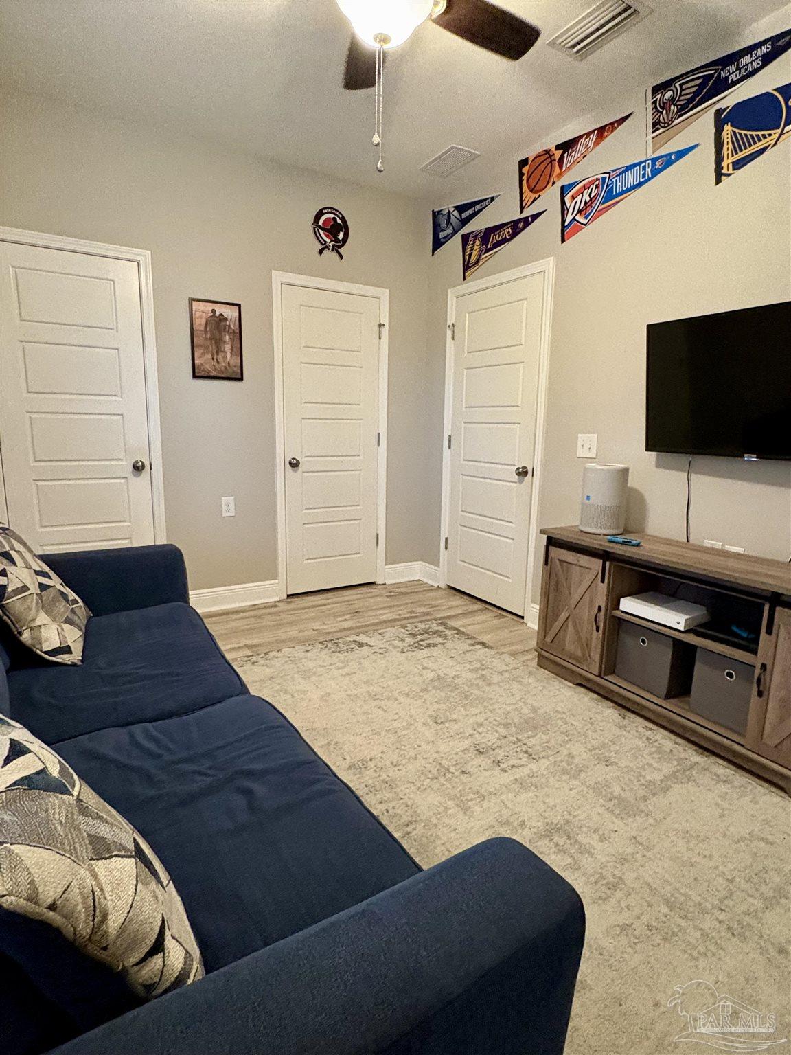 1700 Kahuna Way Cantonment, FL 32533 - Photo 27 of 34 a living room with furniture and a flat screen tv