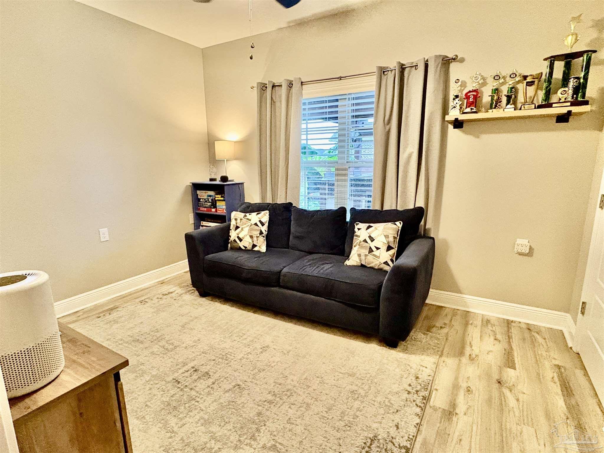 1700 Kahuna Way Cantonment, FL 32533 - Photo 28 of 34 a living room with furniture and a couch