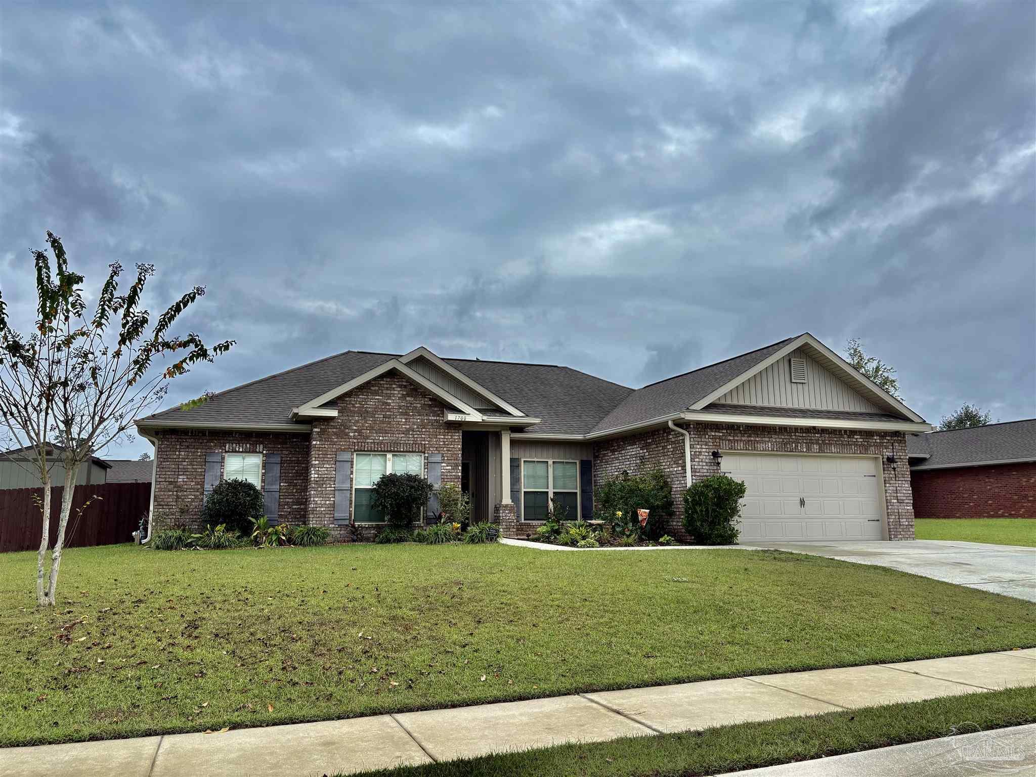 1700 Kahuna Way Cantonment, FL 32533 - Photo 31 of 34 a front view of a house with a garden