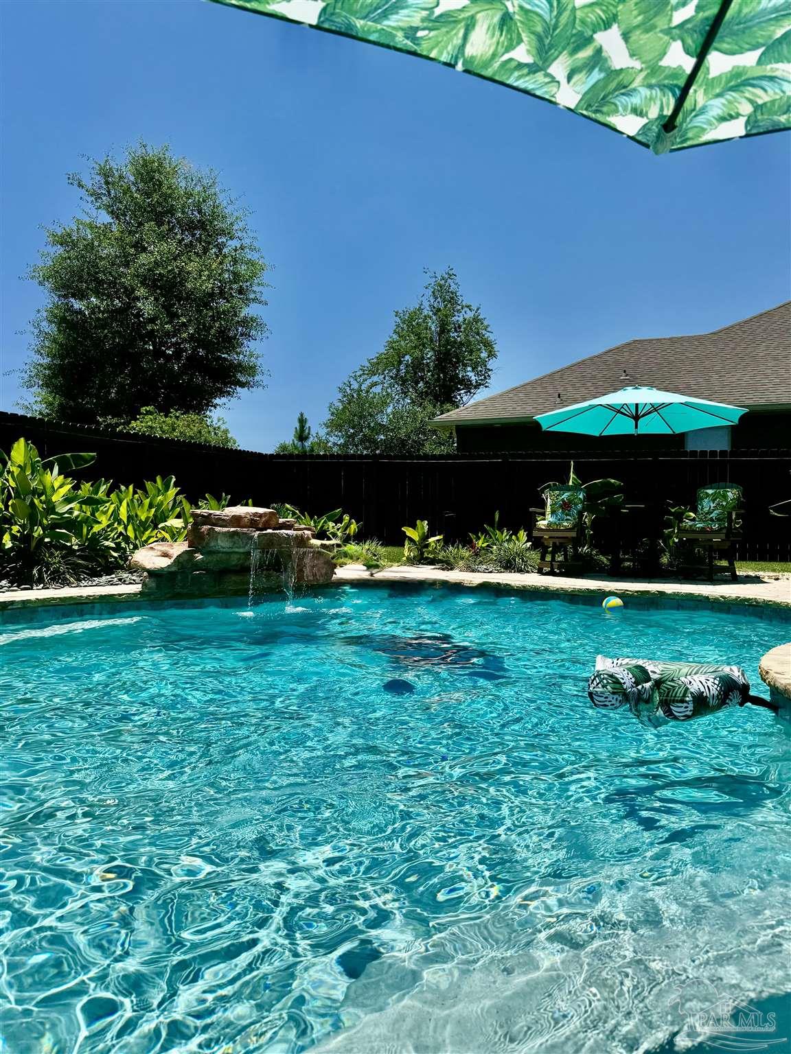 1700 Kahuna Way Cantonment, FL 32533 - Photo 7 of 34 a view of yard with swimming pool and green space