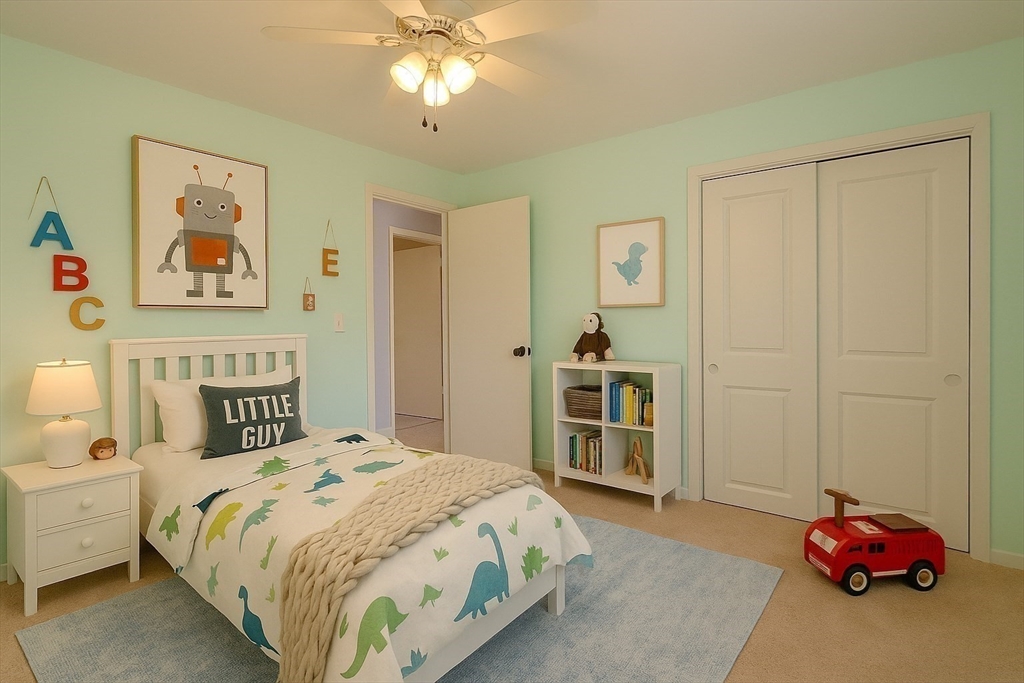3 Tanager Road Goffstown, NH 03045 - Photo 20 of 35 a bedroom with a bed and a chandelier
