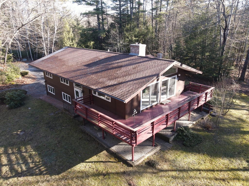 3 Tanager Road Goffstown, NH 03045 - Photo 2 of 35 a view of a patio with a table chairs and a fire pit