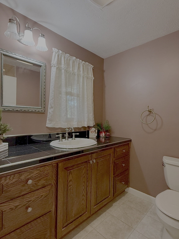 3 Tanager Road Goffstown, NH 03045 - Photo 21 of 35 a bathroom with a sink a toilet and mirror