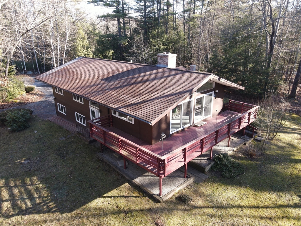 3 Tanager Road Goffstown, NH 03045 - Photo 35 of 35 a view of a patio with a table chairs and a fire pit