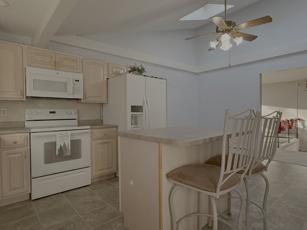 3 Tanager Road Goffstown, NH 03045 - Photo 5 of 35 a kitchen with stainless steel appliances a stove a sink cabinets and a dining table