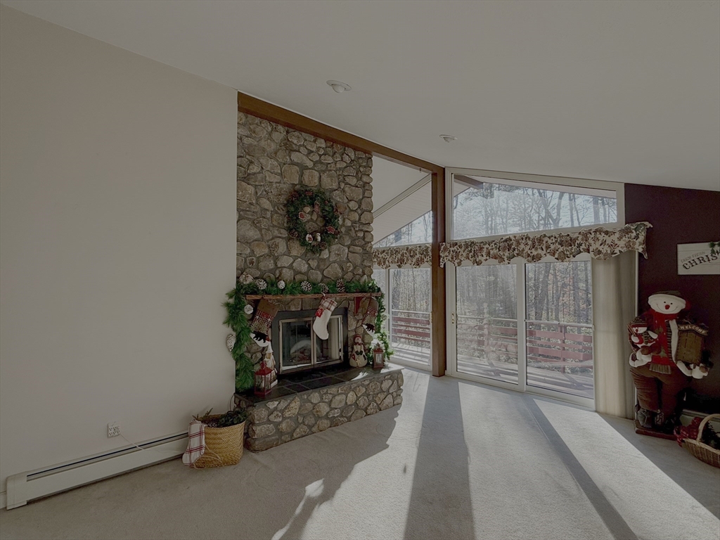 3 Tanager Road Goffstown, NH 03045 - Photo 9 of 35 an empty room with wooden floor and a fireplace