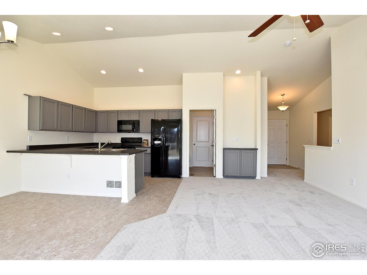 2335 Sublime Drive Windsor, CO 80550 - Photo 15 of 39 a view of kitchen with refrigerator and white cabinets